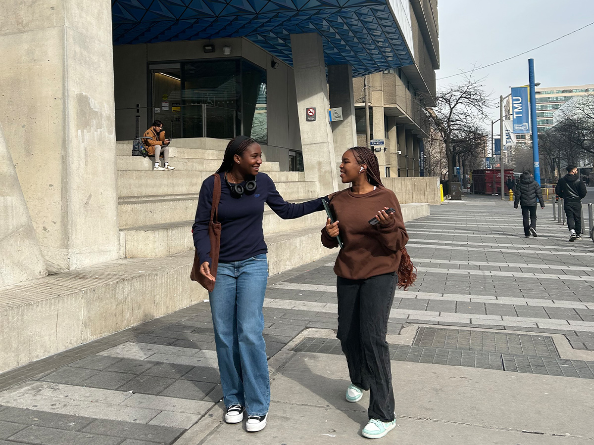 Olo longe having a conversation with her friend in front of the SLC